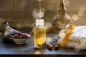 Bottle of argan oil sitting on a wooden table